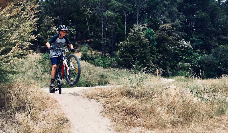 boy riding his bike on rough terrain
