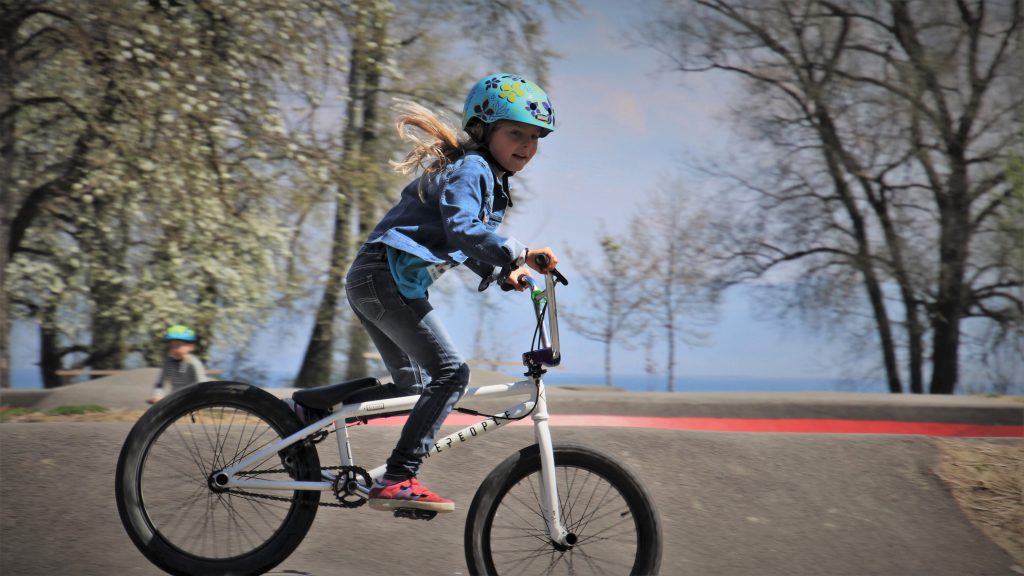 A girl riding a bike in one of the best kids' bike helmets